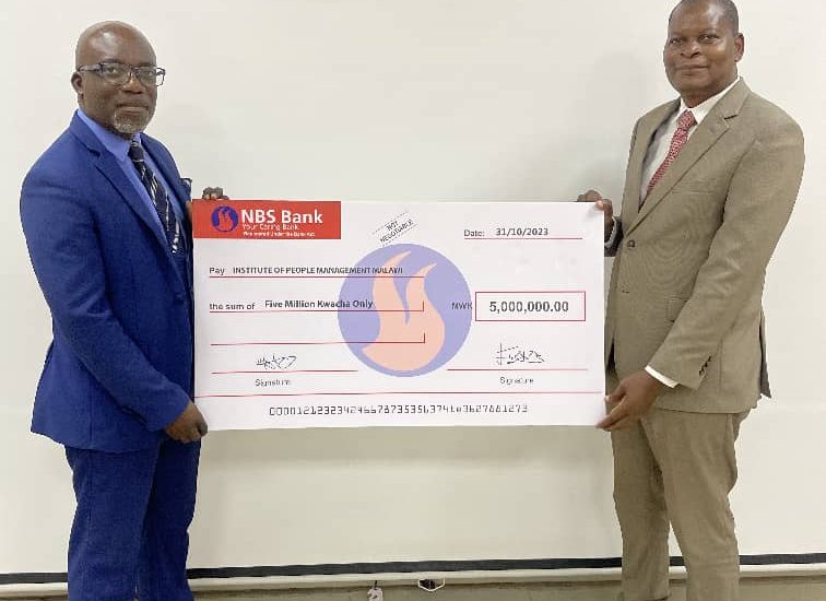 Thunde (right) and Ng’oma display the dummy cheque