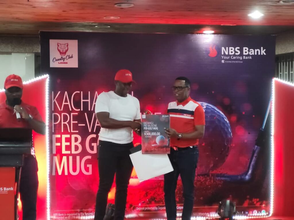 Mwamwani receiving his prize from Chikusilo.