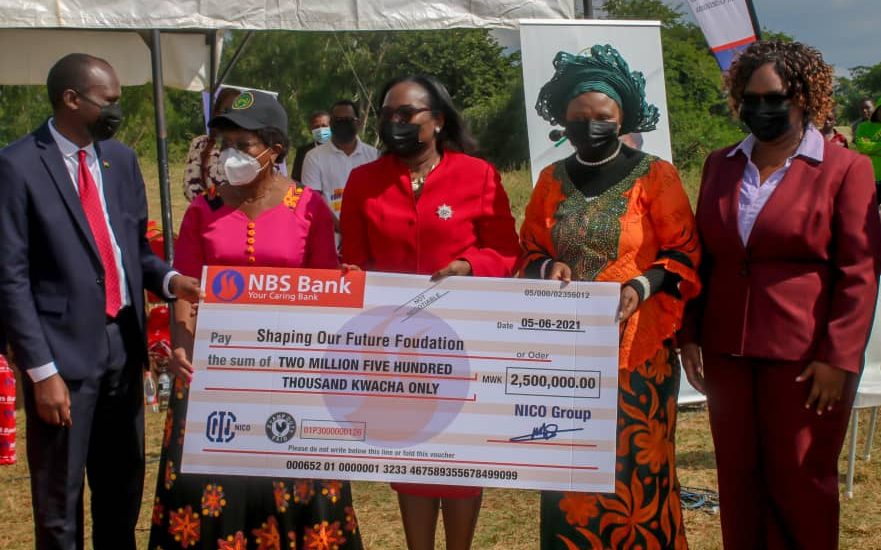 NICO Group officials: Vera Zulu, Ellen Nyasulu and Lillian Moyo, hand over cheque worth K2.5 million to Minister of Education, Hon. Agnes NyaLonje and Acting Executive Director of Shaping Our Future Foundation, Mr MacDuff Phiri