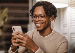smiley-man-using-modern-smartphone-device-home