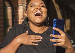 teenager-girl-laughing-while-holding-her-phone