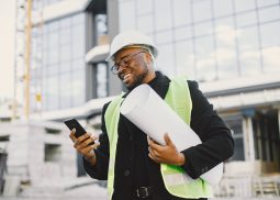 Black architect with project talk by phone